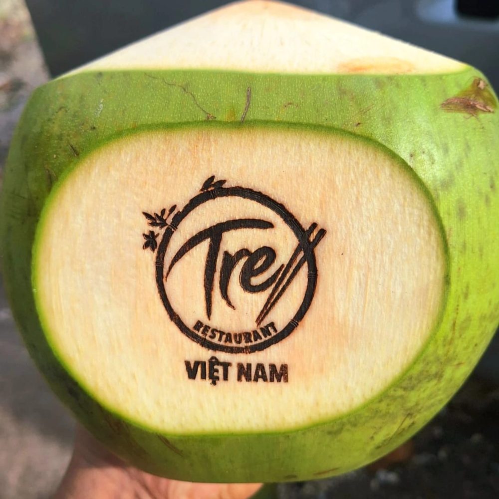 Fresh coconut with the Tre logo burned into it